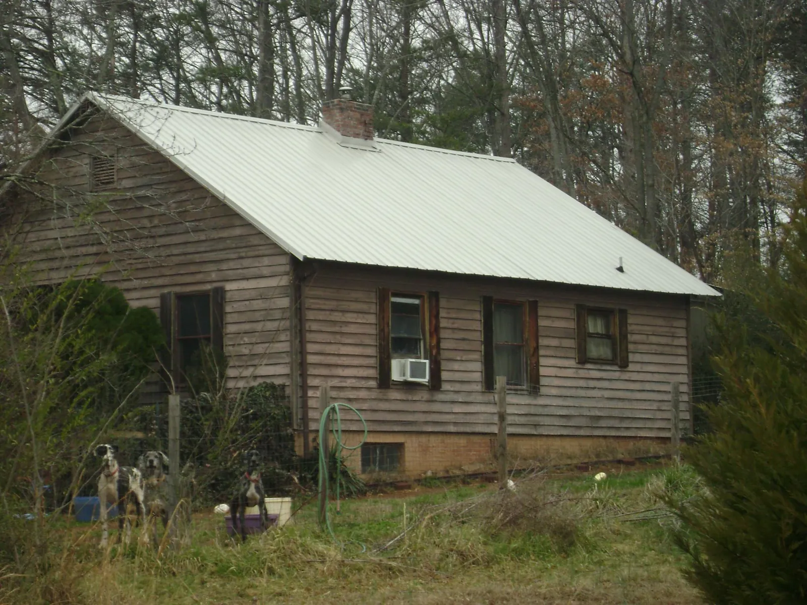 White metal roof on an old wood sided farmhouse, from a Metal Roof Installation job in Gilberton